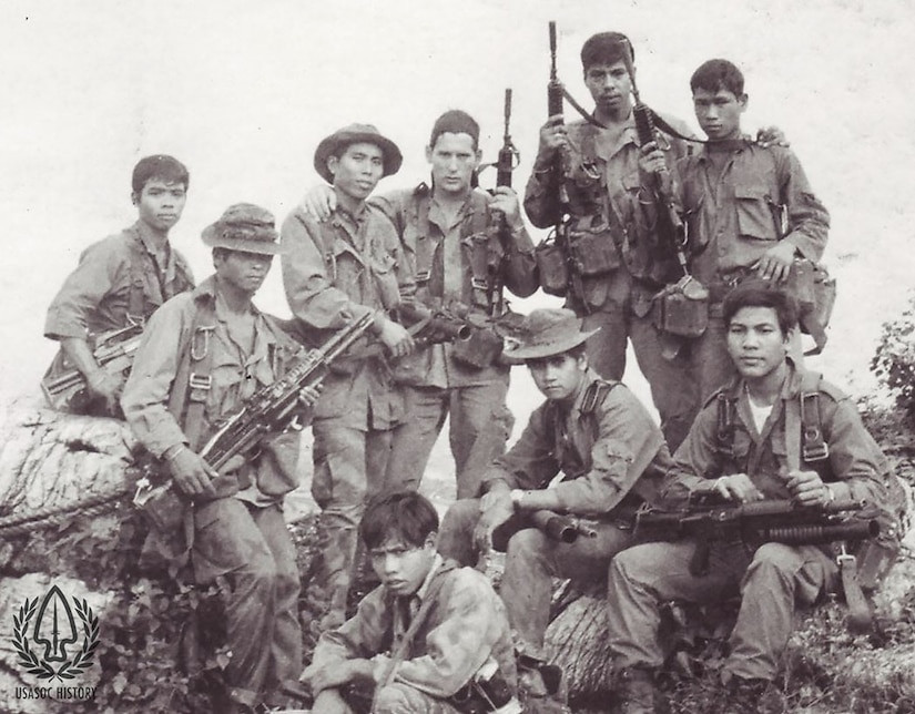 Nine soldiers in combat uniforms, reflecting the collaborative efforts in Vietnam.