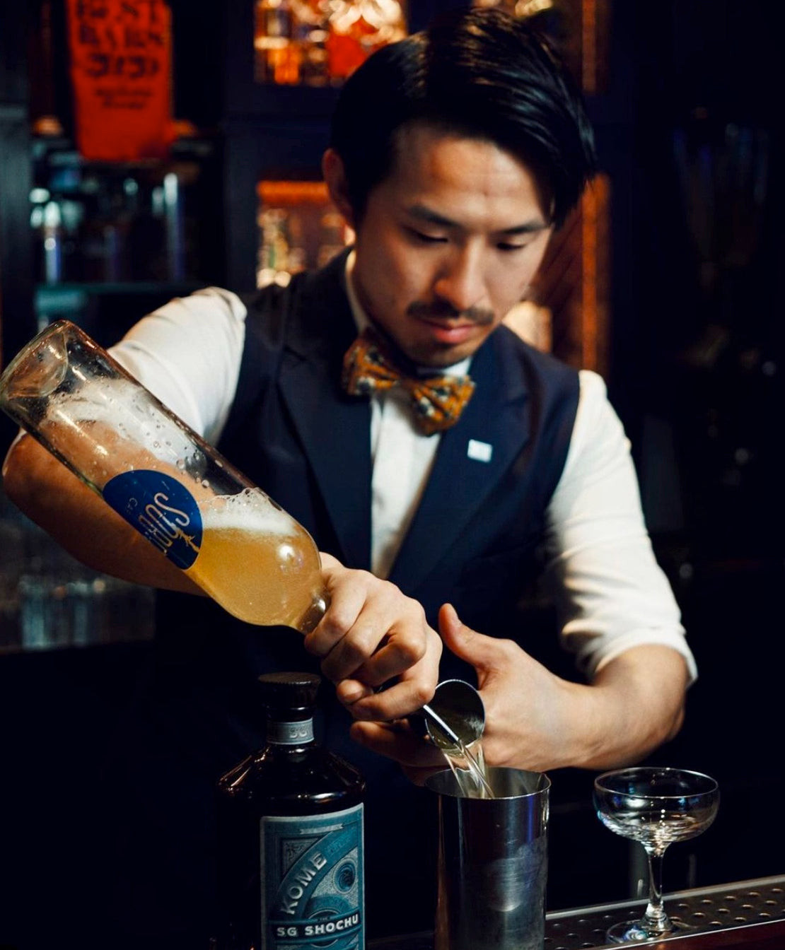 Bartender at Sober Company wearing a vest and bowtie, presenting another style within the bar's diverse bartender uniform program.