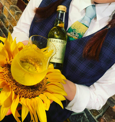 Close-up of bartender uniform at Benfiddich, focusing on the plaid vest and unique bowtie detail that adds personality to the attire.