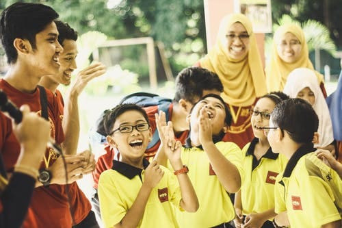Students in school uniforms showing school spirit, representing pride and institutional belonging