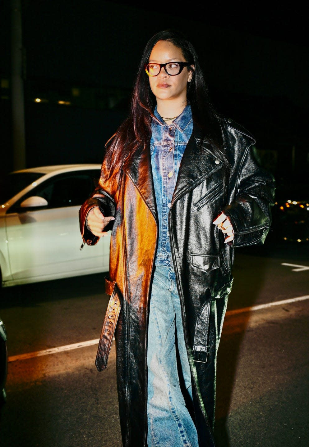 Rihanna confidently strides in her stylish cowboy-inspired uniform, showcasing her fashion-forward approach.
