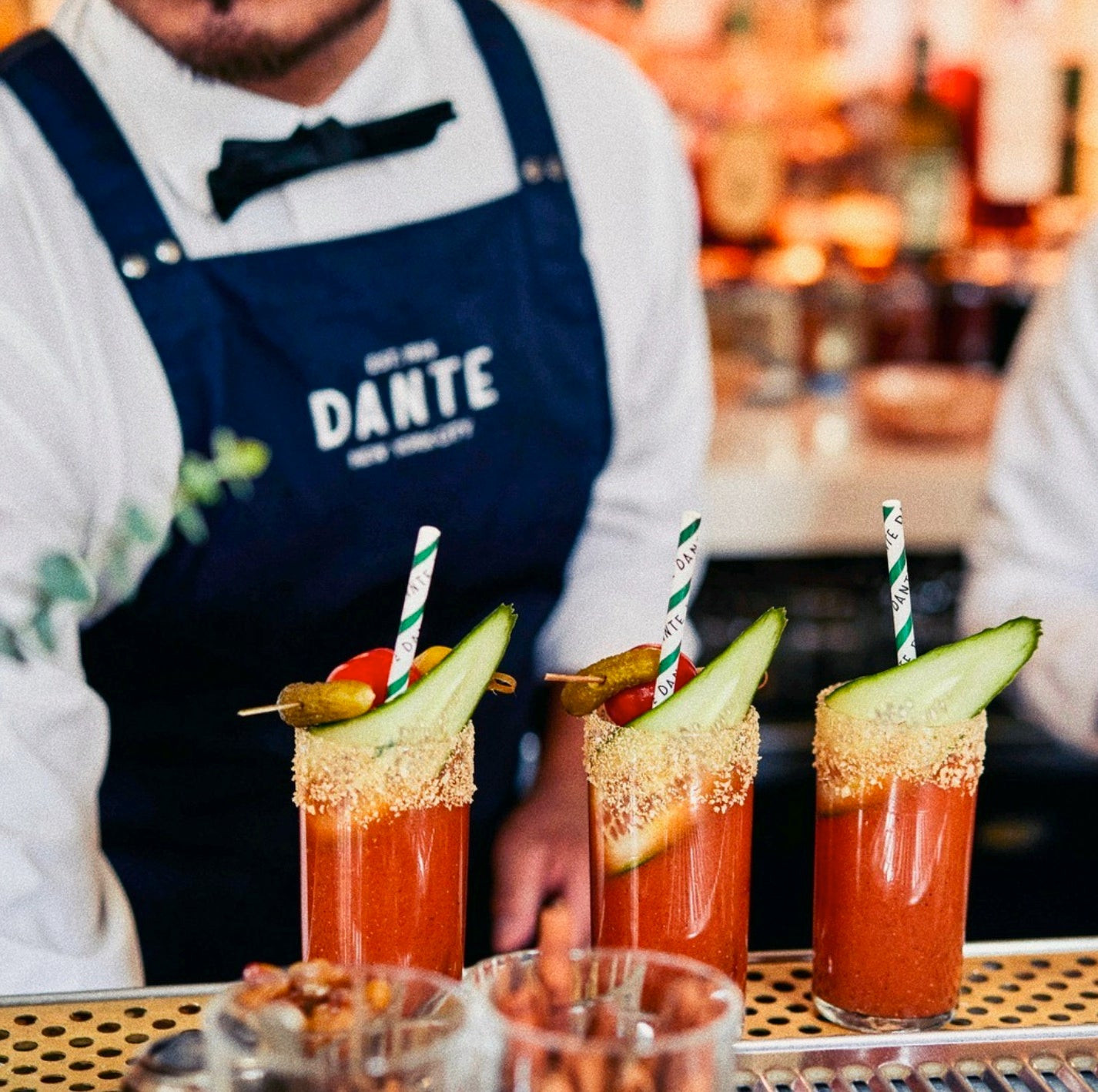 Detail of Dante bartender uniform apron with metal studs and logo, enhancing the overall look of the smart-casual attire.