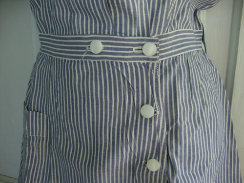 Close-up of mother of pearl buttons on an old nurse uniform