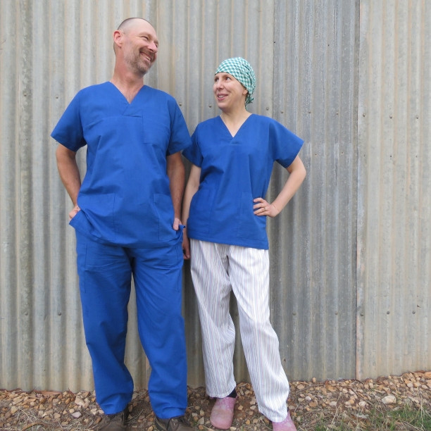 Two individuals showcasing the free scrub uniform patterns, emphasizing the unisex design.