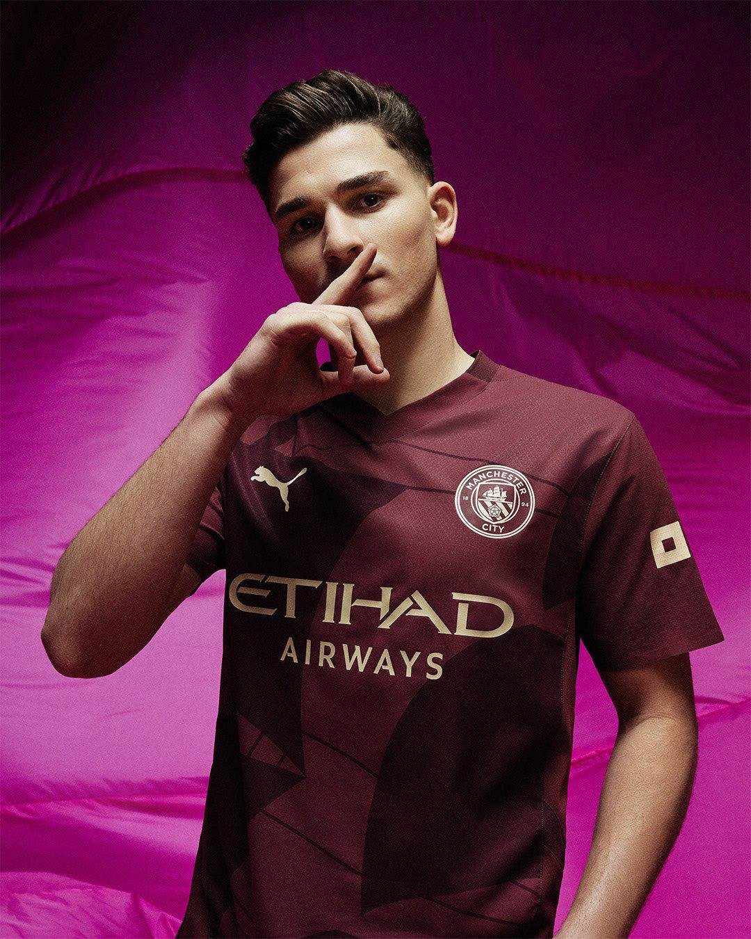 Manchester City 2024-2025 Home Jersey: A claret and gold design by Puma.