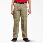 Boy wearing khaki Dickies uniform pants standing confidently