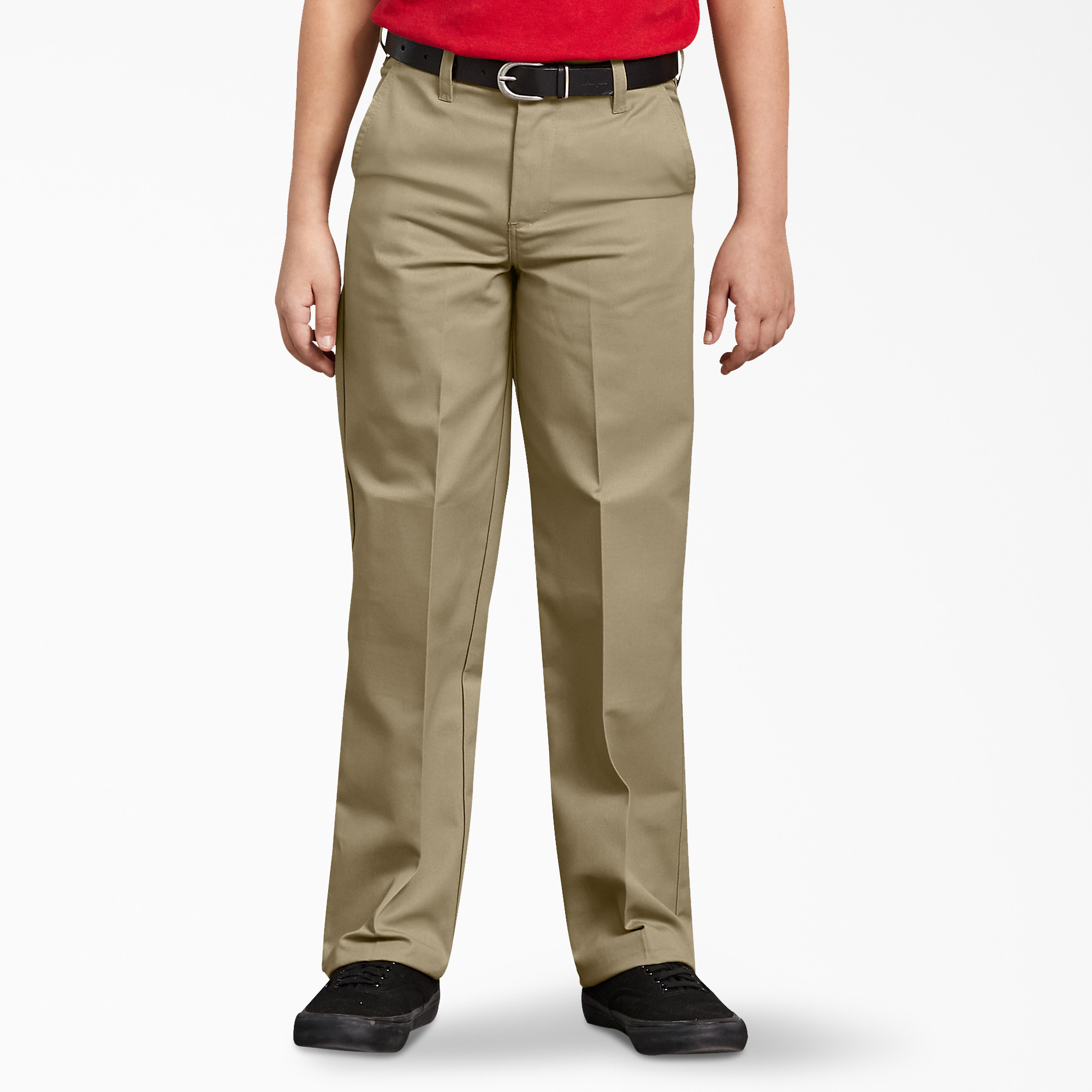 Boy wearing khaki Dickies uniform pants standing confidently