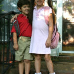 Two smiling school children wearing Lands' End uniforms.