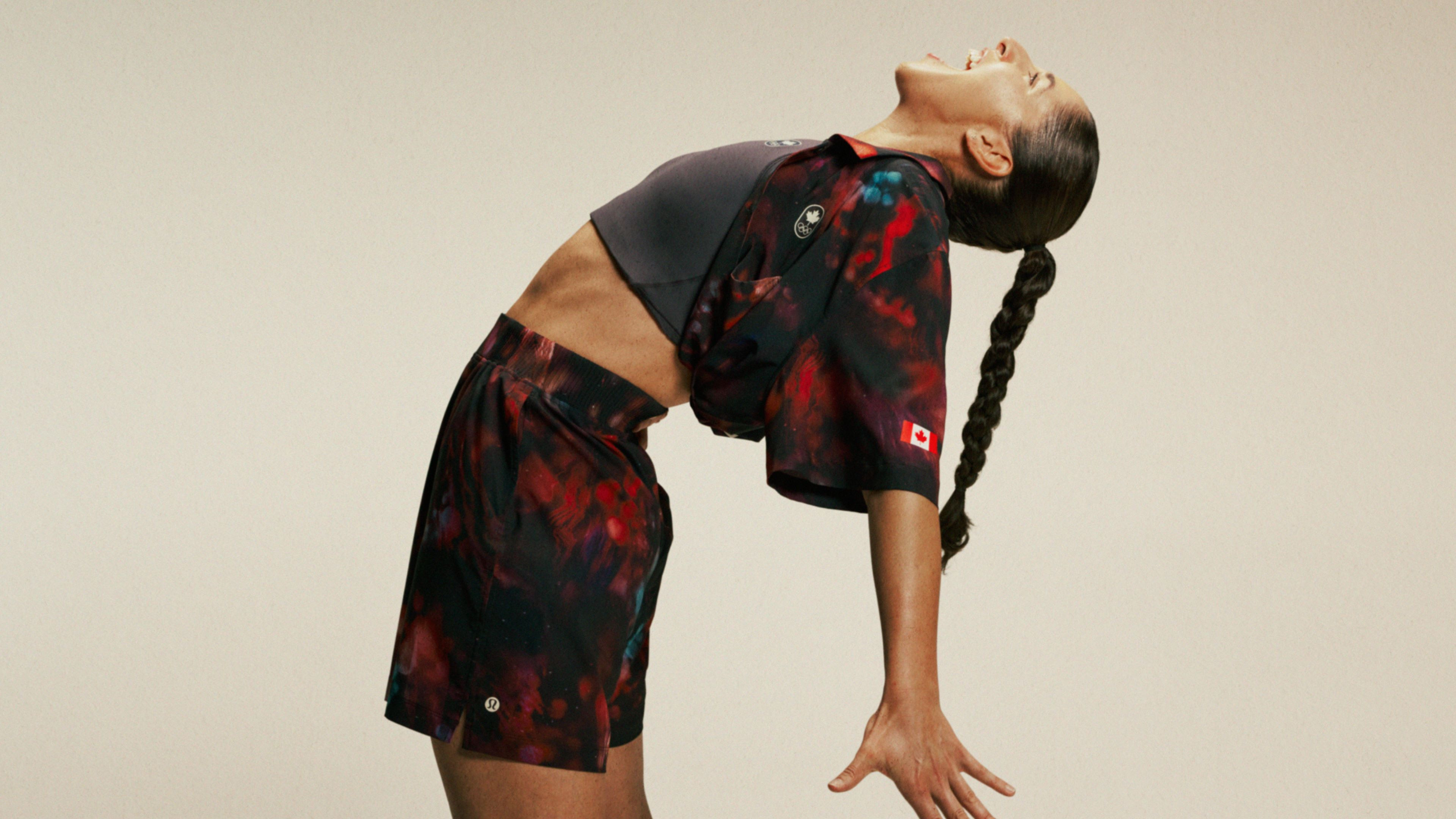 Melissa Humana-Paredes, Canadian beach volleyball player, models the Team Canada Closing Ceremony uniform by Lululemon, featuring the Northern Lights inspired illumination print on a button-down shirt.