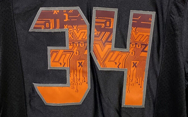 Close-up of the circuit board pattern on the numbers of the Virginia Tech 2010 Nike Pro Combat uniform, highlighting the orange and maroon design.