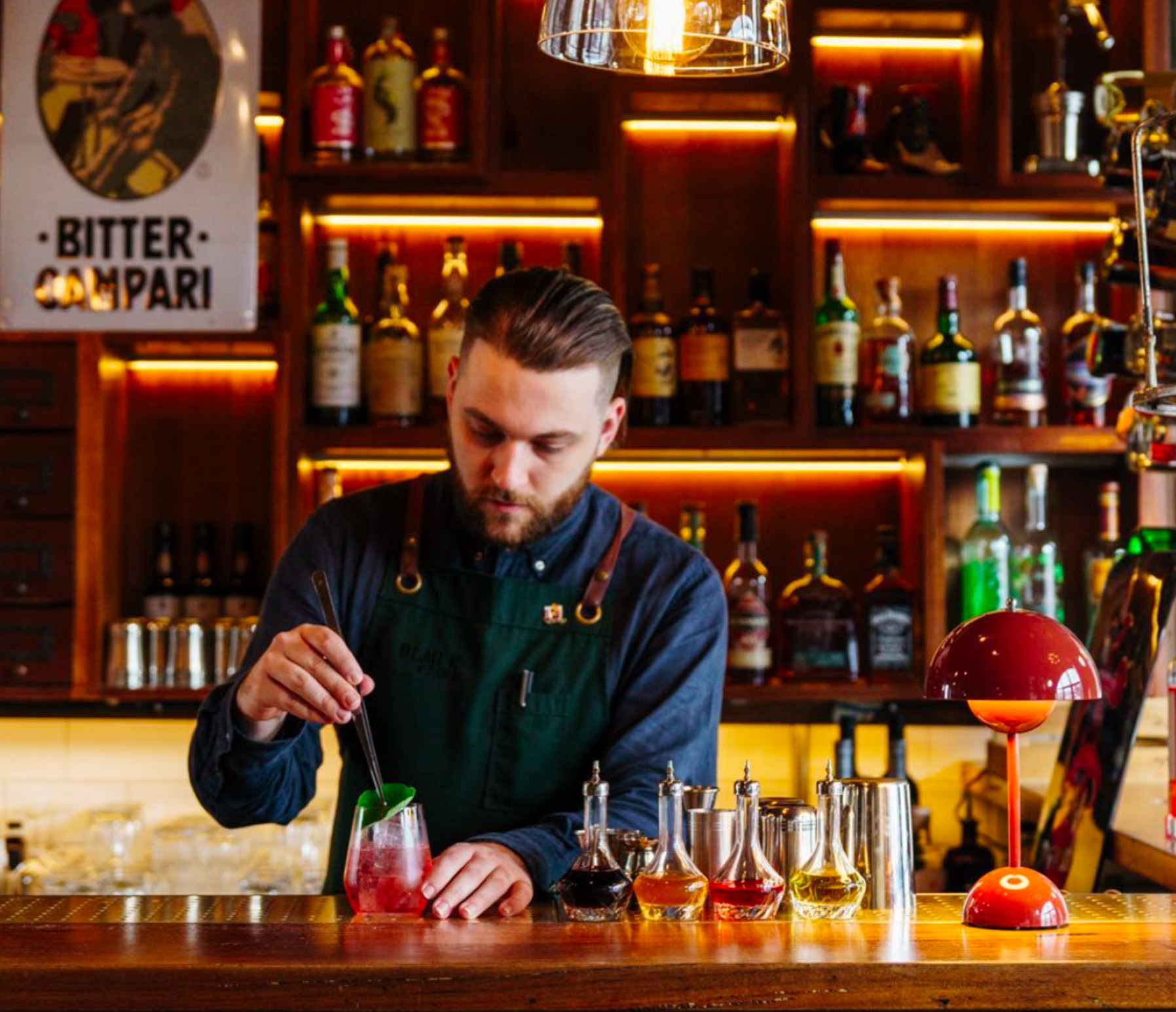 Bartender uniform detail at Black Pearl showing functional pockets on the apron, combining style with practicality for busy bartenders.