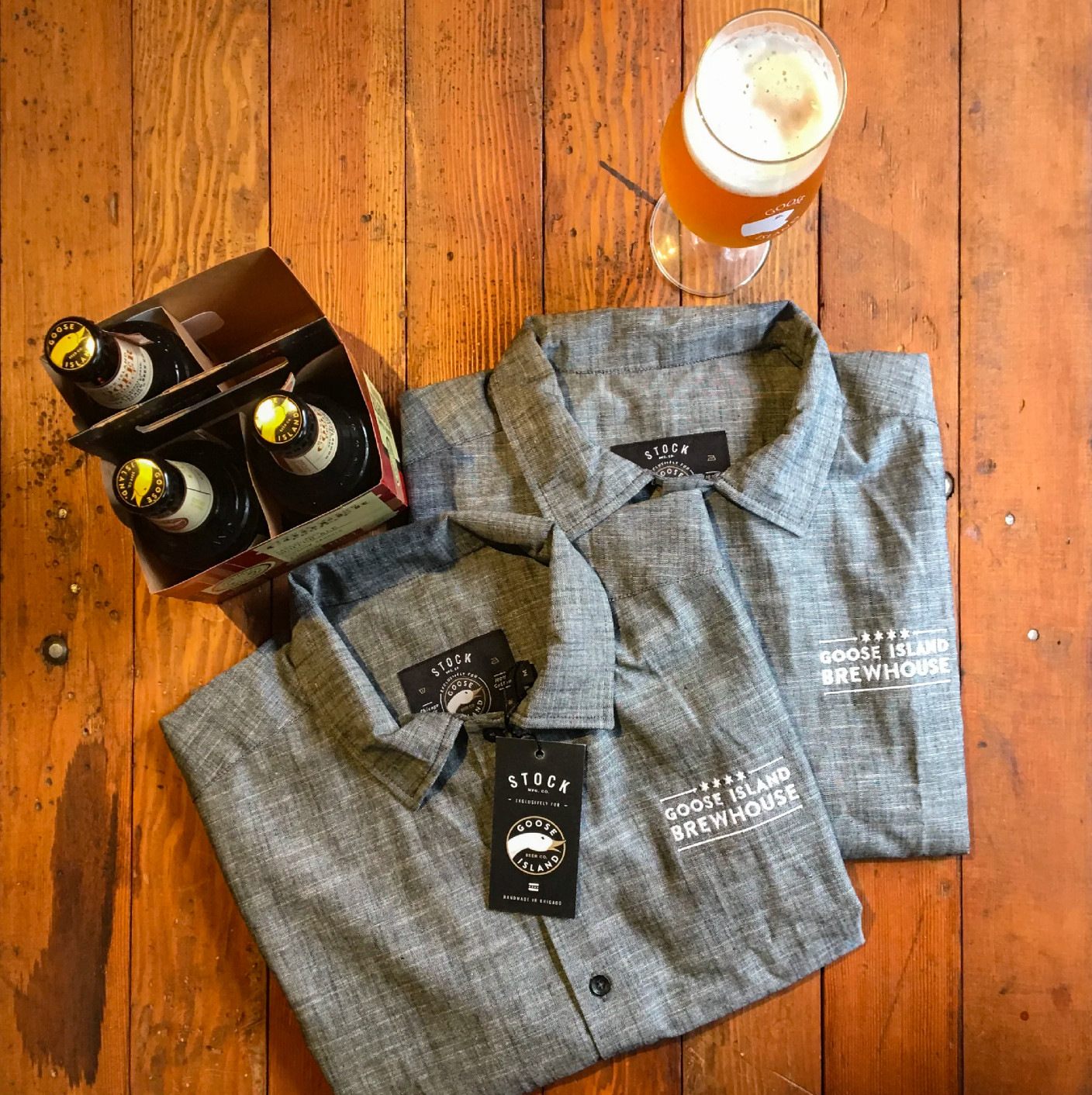 Bartenders at Goose Island Brewhouse wearing embroidered chambray shirts with custom co-branded labels, designed by Stock Manufacturing.