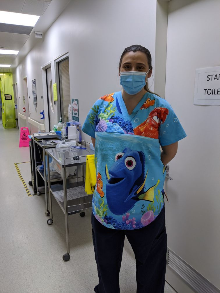 Action shot of a maternity scrub top based on free uniform patterns, demonstrating fit and functionality.