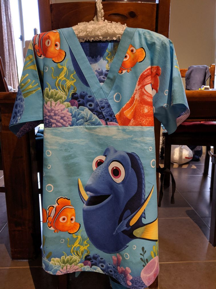 Front view of a maternity scrub top based on the free uniform patterns, showing adaptation for pregnancy.