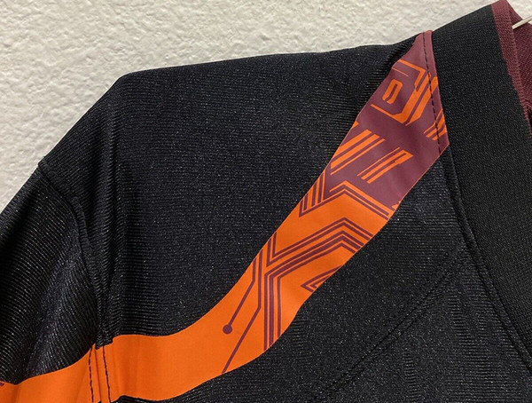 Detailed view of the circuit board design on the shoulder of the Virginia Tech uniform, showing the intricate pattern and color combination.