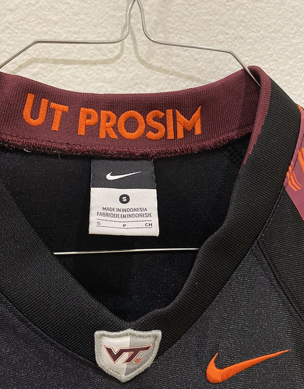 Close-up of the back of the Virginia Tech helmet showing "Ut Prosim" detail, part of the 2010 Nike Pro Combat uniform design.