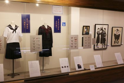 A museum exhibit displaying various sailor uniforms and information on how to tie school uniform knots.