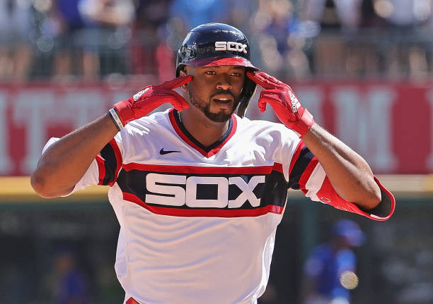 Eloy Jimenez of the Chicago White Sox celebrating in a throwback uniform