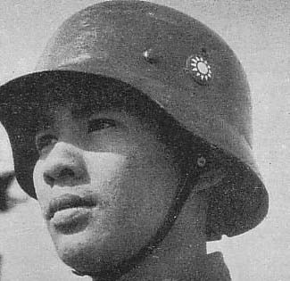 Chinese soldier wearing an enamel cap badge applied to the side of his helmet instead of a painted insignia