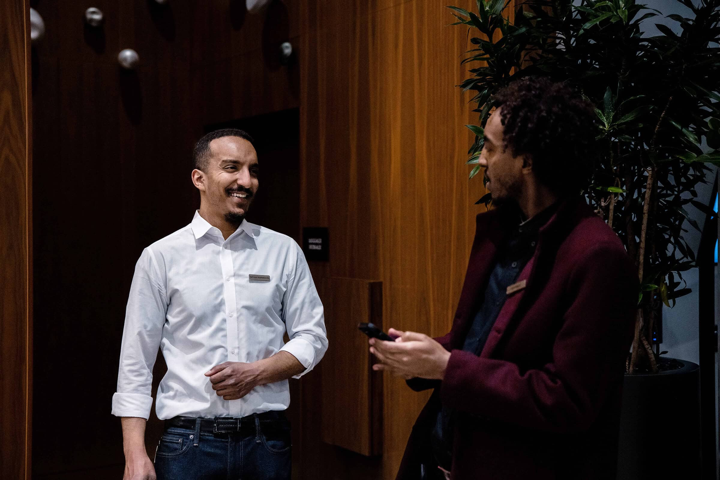 Two Marriott associates in conversation at Marriott HQ Hotel, showcasing a professional yet approachable atmosphere