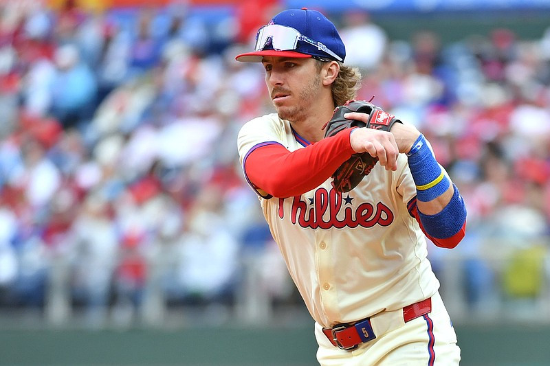 Philadelphia Phillies second base Bryson Stott throws to first base